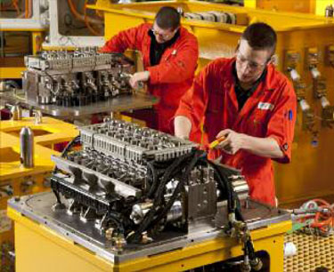 engineers working on an engine